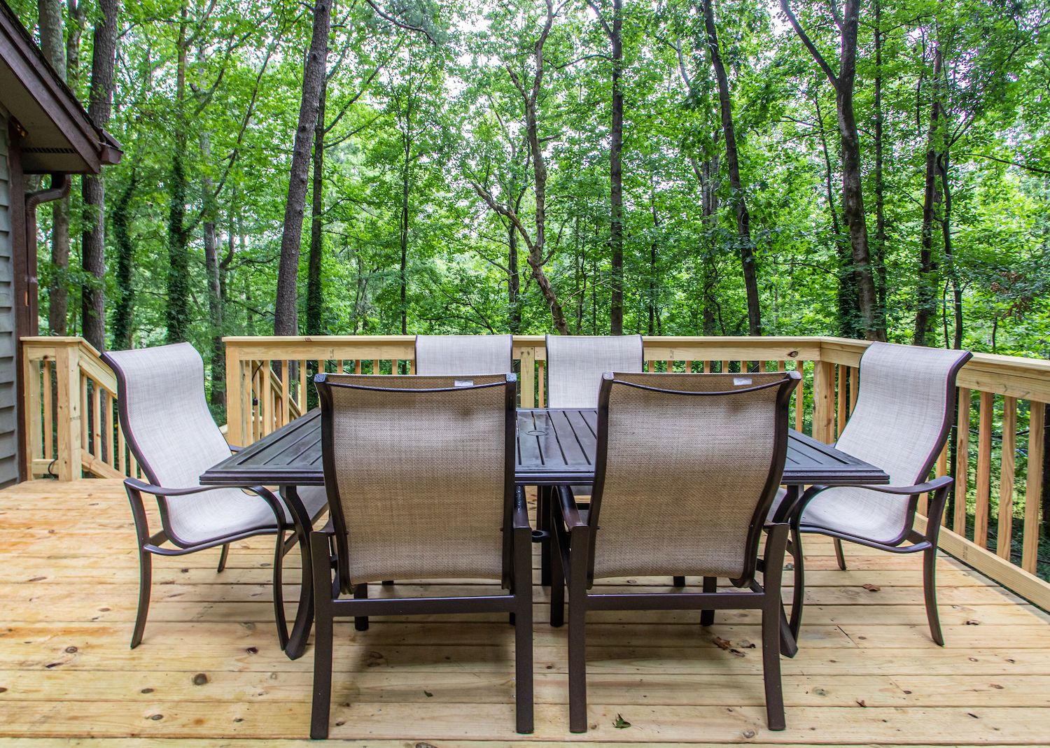 Outdoor wooden deck with table and chairs.